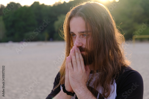 Photos Portrait of handsome bearded young man with long hair