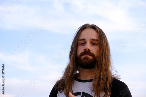 Photos Portrait of handsome bearded young man with long hair