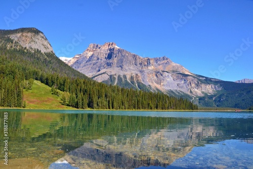 Beautiful blue Emerald Lake with reflection of the mountains in the water. Sunny day, blue sky. Canada.