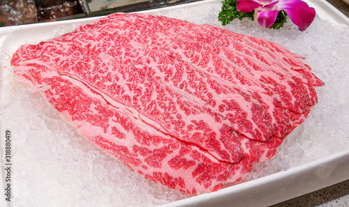A plate of raw sliced premium beef.