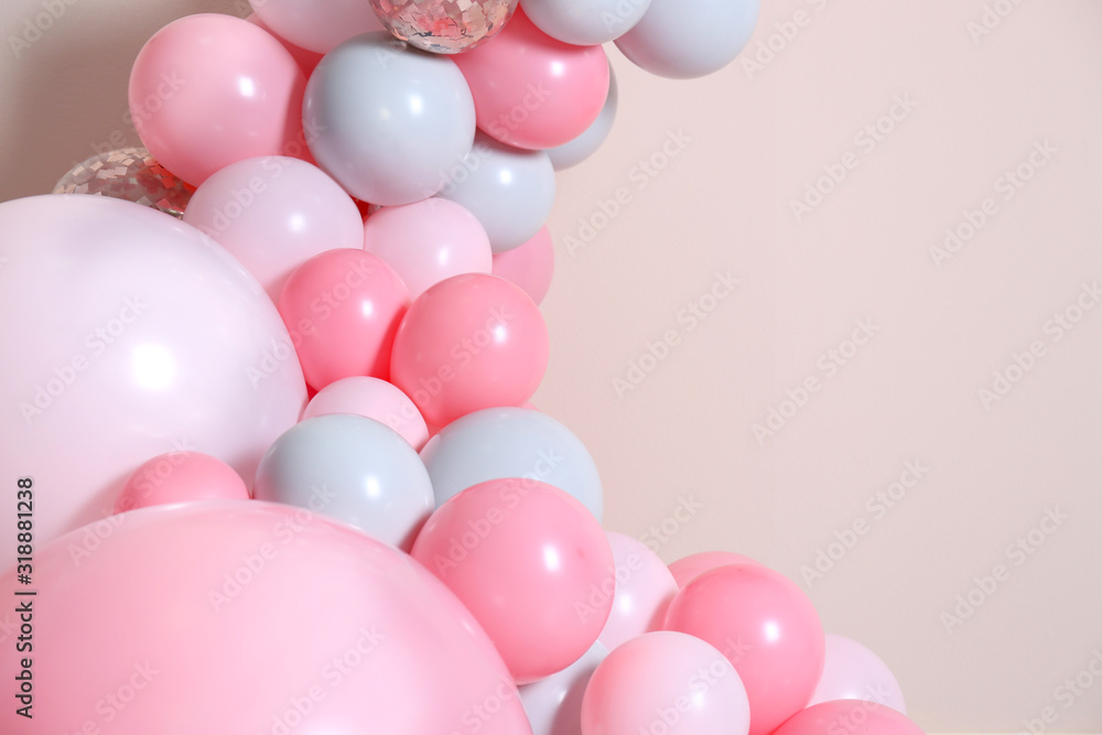 Beautiful composition with balloons on beige background, closeup. Space for text