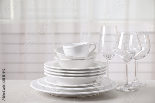 Set of clean tableware on light grey marble table