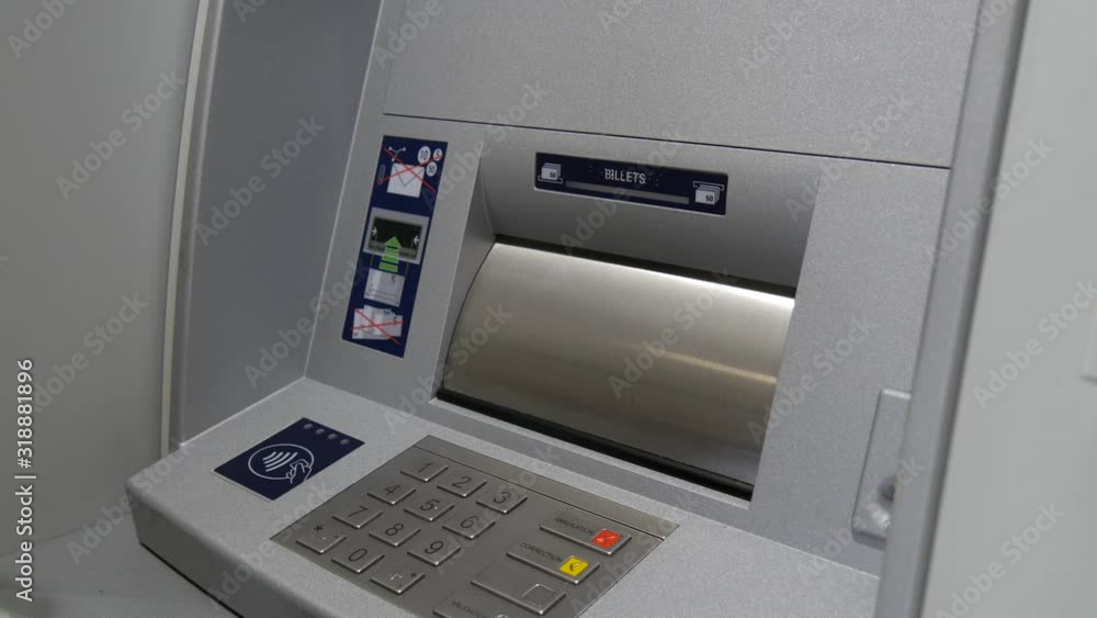 woman using his credit card in an atm for cash withdrawal woman using his credit card in an atm for cash withdrawal