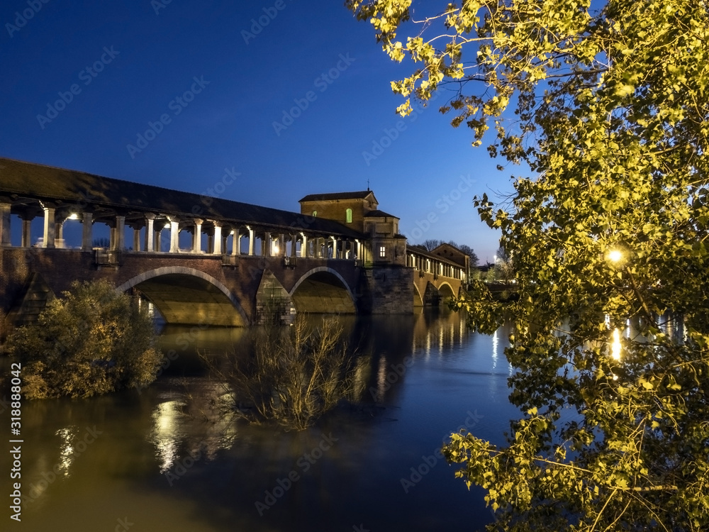 View of Ponte Vecchio bridge during the flooding of Ticino river in Pavia, Italy