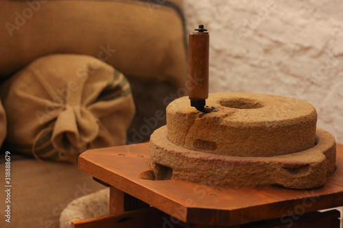 Schilderij op canvas Small historical flour mill with handle and in background flour sacks