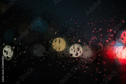 glare on wet glass at night. raindrops on the window. city lights at night.