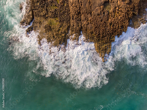 Aerial view, waves crash on a rocky shore. Portugal.