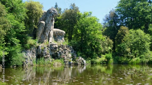 Firenze province local landmarks of tuscany region. the majestic big statue of Colosso dell Appennino giant statue and pond in public gardens of Pratolino near Florence in Italy - horizontal panning 