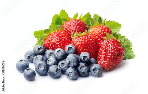 Strawberries and blueberries on white background .