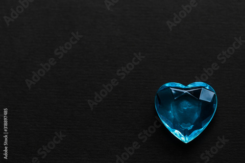 Blue glass faceted heart on a black background blank postcard