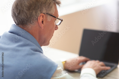 Unrecognizable Gentleman Working On Laptop Sitting At Workplace