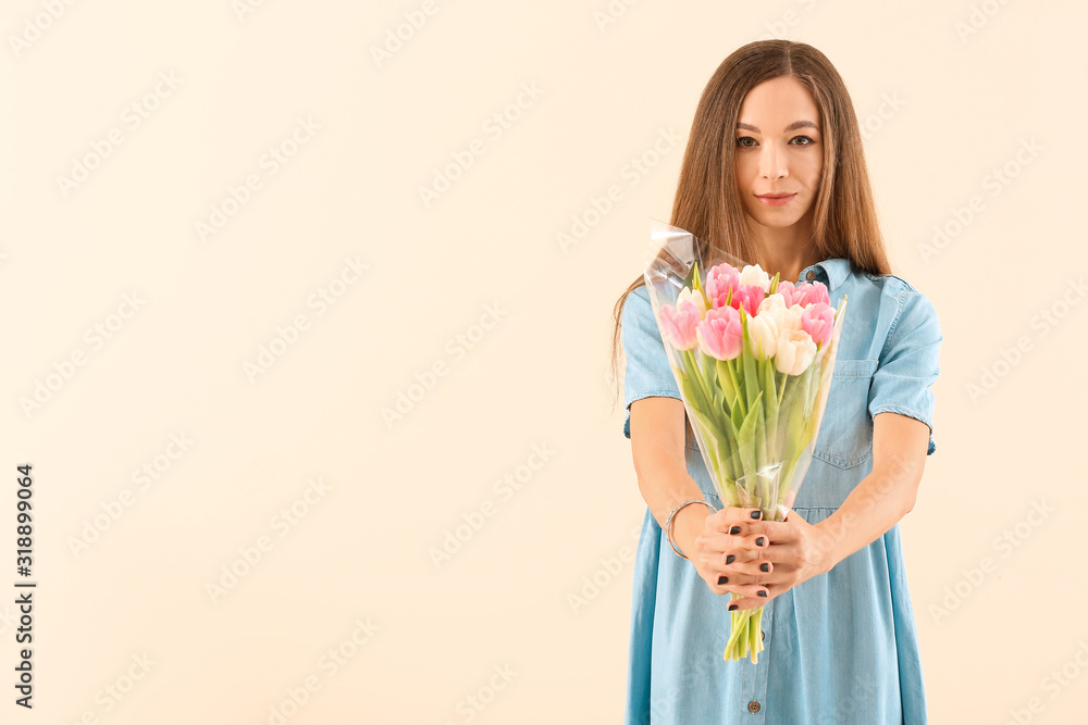 Beautiful young woman with flowers on color background. International Women's Day celebration Beautiful young woman with flowers on color background. International Women's Day celebration