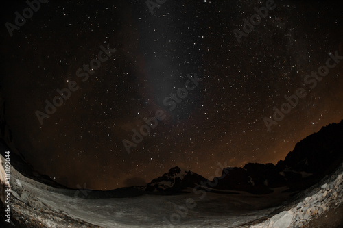 Shot of stars above the rocky mountains and hills