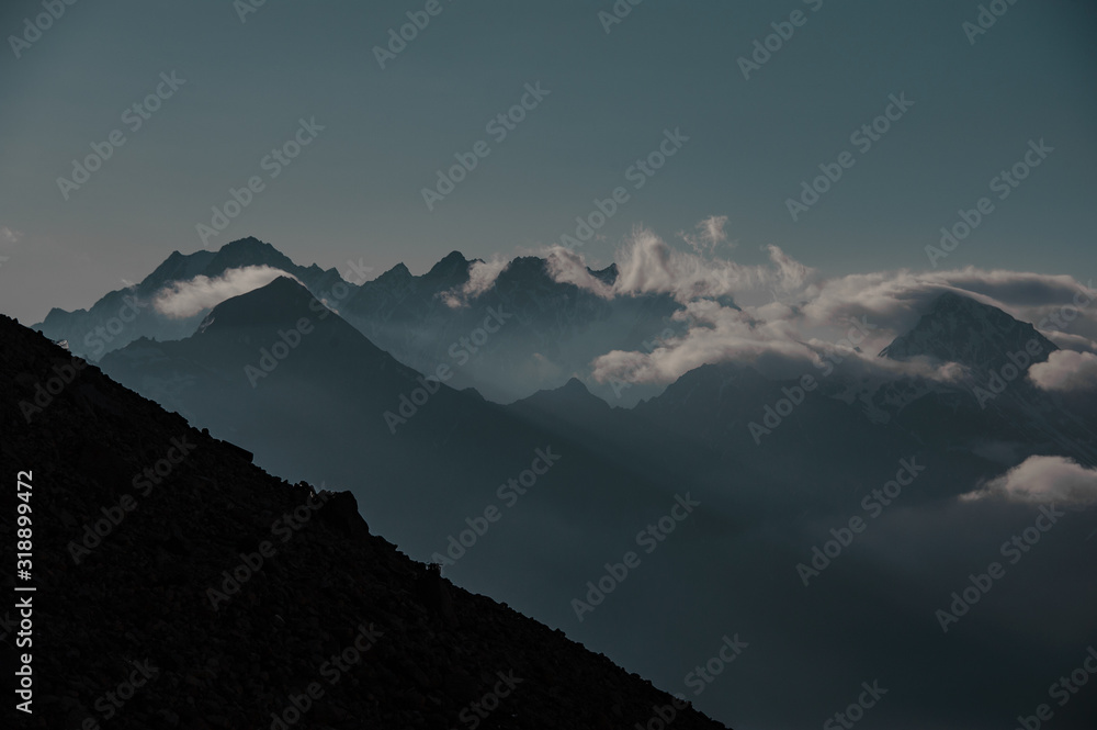 Obraz premium Silhouette of a mountain slope in front of ridge