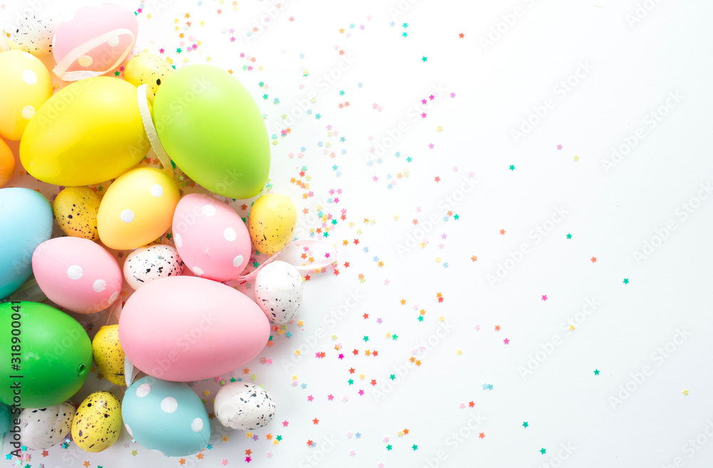 multi-colored bright easter eggs lie on a white background