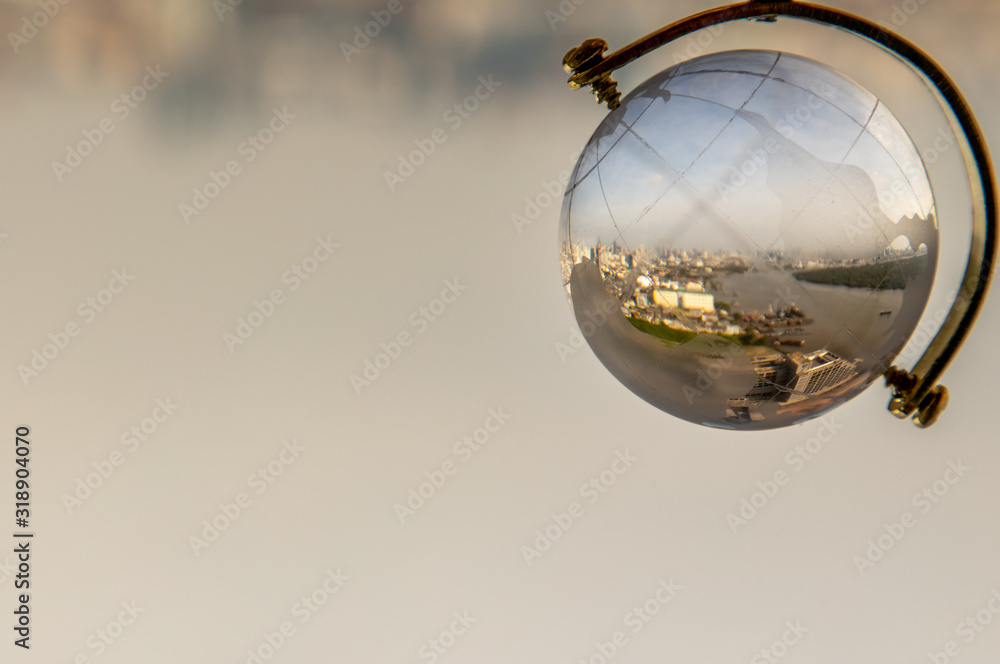 Looking through crystal globe showing city skyline. Looking through crystal globe showing city skyline.