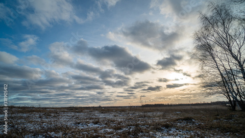 Beautiful setting sun over frozen field