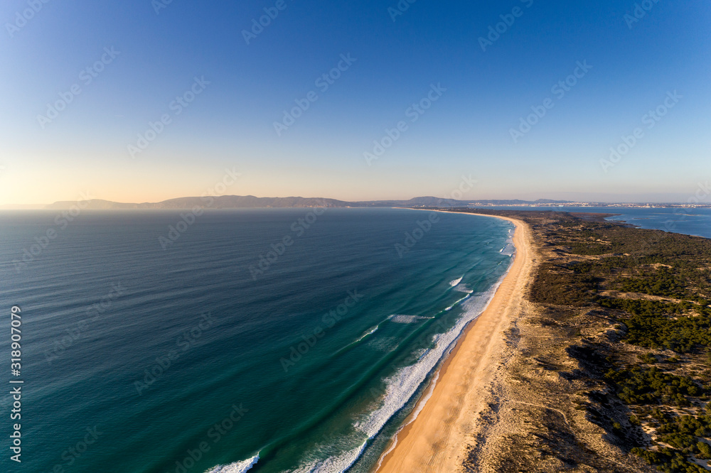 Aerial view of the Comporta Beach and the Troia Peninsula with the Arrabida Mountain on the background, in Portugal.