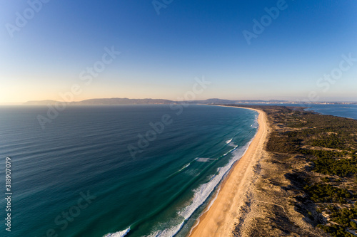 Aerial view of the Comporta Beach and the Troia Peninsula with the Arrabida Mountain on the background, in Portugal.