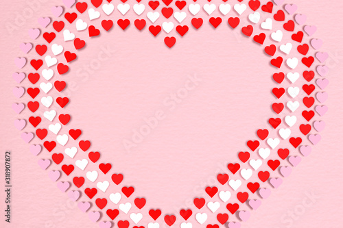 Red hearts on pink paper background  Flat lay. Design for Valentine day concepts.
