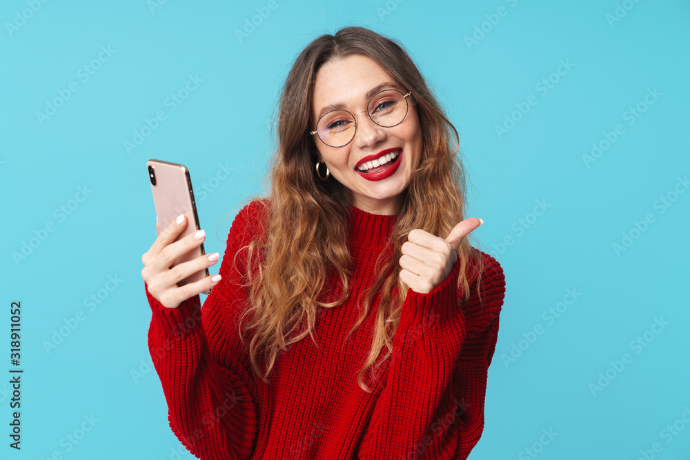 Naklejka premium Image of delighted nice woman using cellphone and showing thumb up