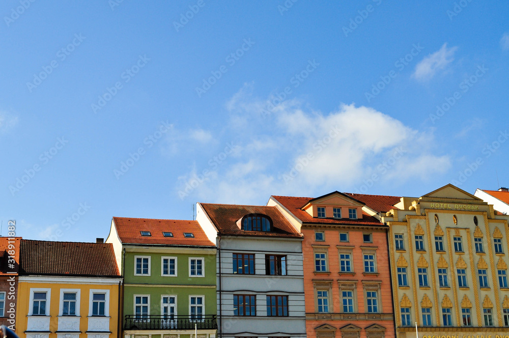 Typical colorful houses buildings with multicolored facade and windows, blue sky background in budweis czech republic