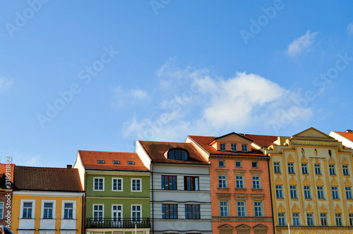Typical colorful houses buildings with multicolored facade and windows, blue sky background in budweis czech republic
