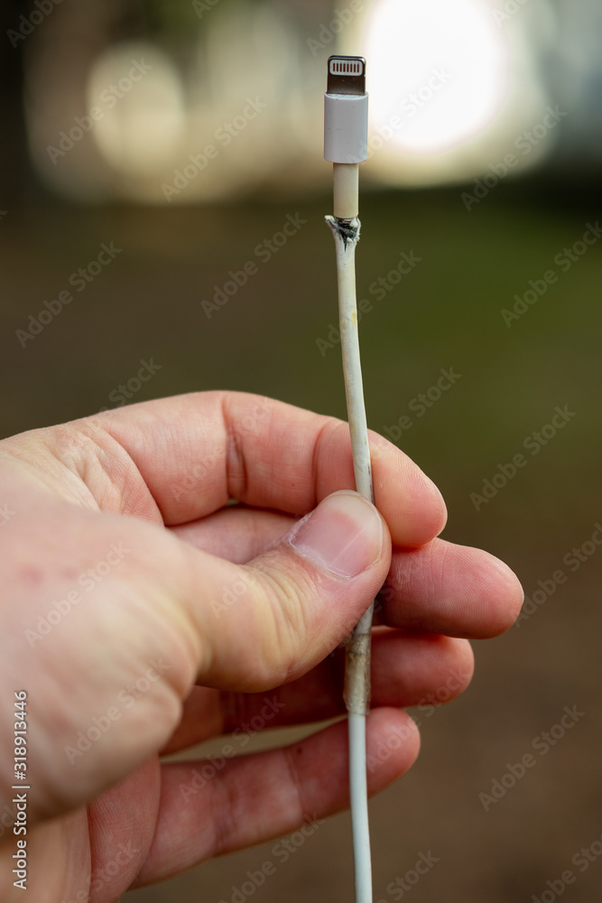 Close-up of broken smartphone's charger cable Close-up of broken smartphone's charger cable