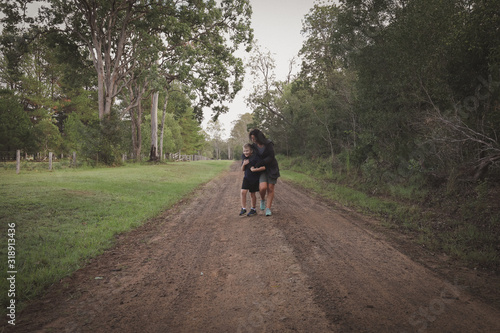 Mother and son walking together down country lane © Caseyjadew