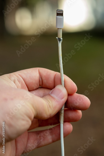 Close-up of broken smartphone's charger cable