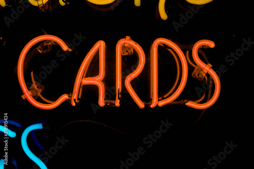 red cards neon sign on black isolated background copy space