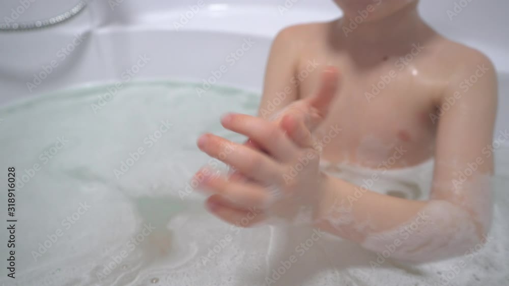 6-7 years old boy taking a bath, baby washes his head 6-7 years old boy taking a bath, baby washes his head