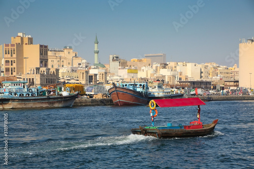 Dubai Creek is a saltwater creek located in the center of the city dividing it in two. Busy river with fishing boats & water taxis, United Arab Emirates.
