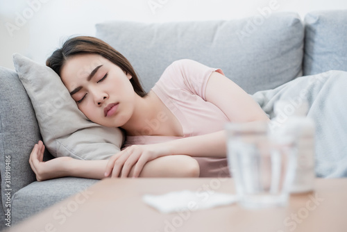 Bild auf Leinwand The sick asian woman is sleeping after swallowing pills.