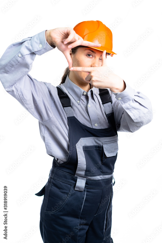 Girl in a construction helmet makes measurements with hand gestures. isolated Girl in a construction helmet makes measurements with hand gestures. isolated