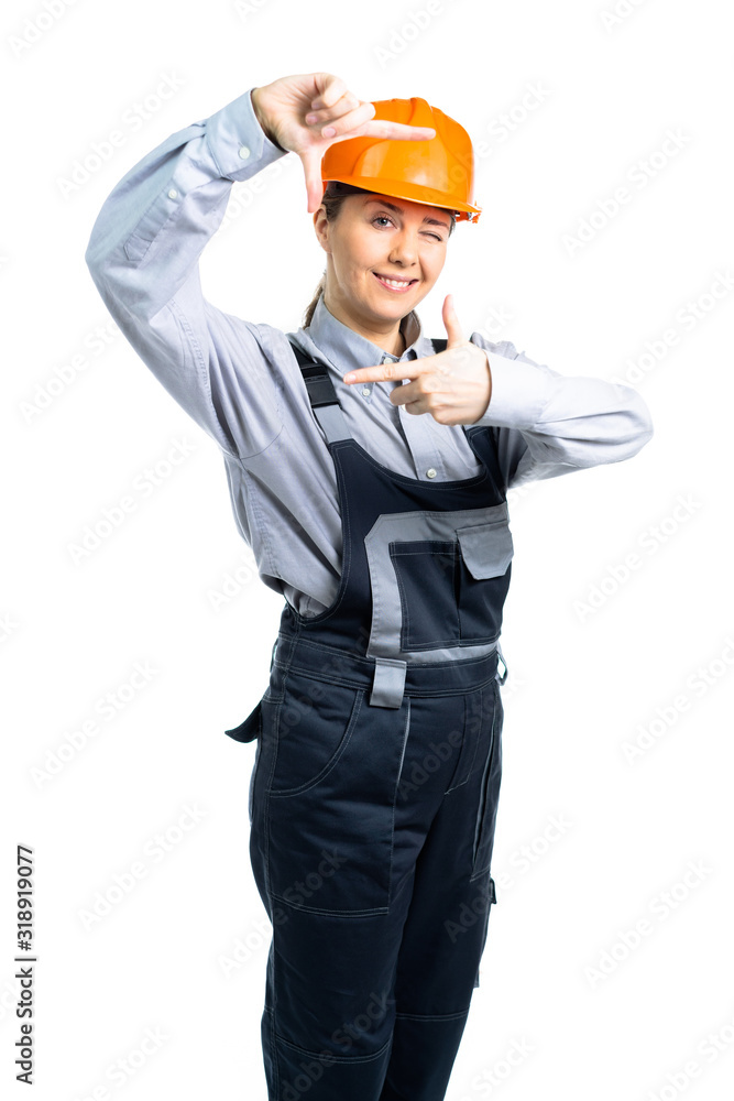 A female construction team leader smiles and takes measurements with hand gestures. Isolated A female construction team leader smiles and takes measurements with hand gestures. Isolated