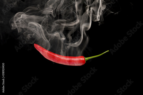 Fresh red chillies with smoke on a black background Concept chili that is spicy and hot