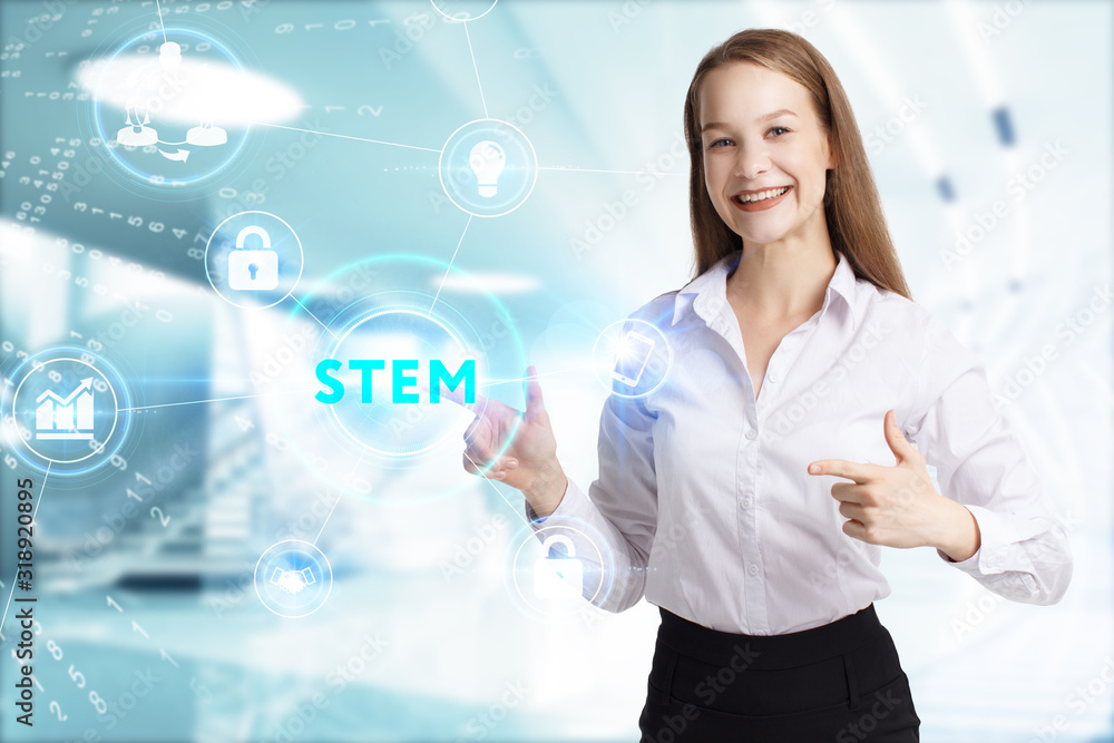 Business, Technology, Internet and network concept. Young businessman working on a virtual screen of the future and sees the inscription: STEM Business, Technology, Internet and network concept. Young businessman working on a virtual screen of the future and sees the inscription: STEM