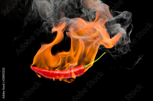 Red chilli with flame  black background  the concept of spicy - pictures
