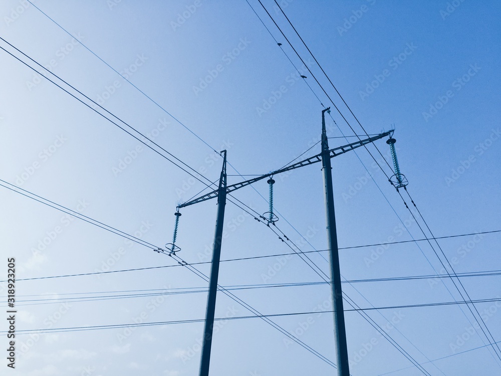 Power lines on background of blue sky