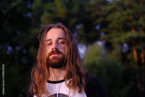 Tableau sur toile Portrait of handsome bearded young man with long hair