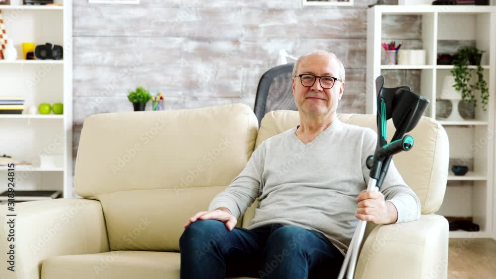 Portrait of elderly retired man smiling to the camera in cozy nursing home Portrait of elderly retired man smiling to the camera in cozy nursing home