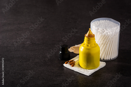 Medical iodine in a bottle and gauzes on black background. Copy space	 photo