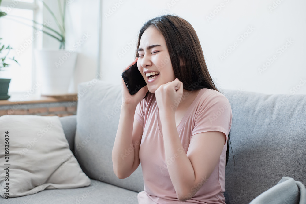 A teenage Asian girl was happy with what was in her cell phone. A teenage Asian girl was happy with what was in her cell phone.