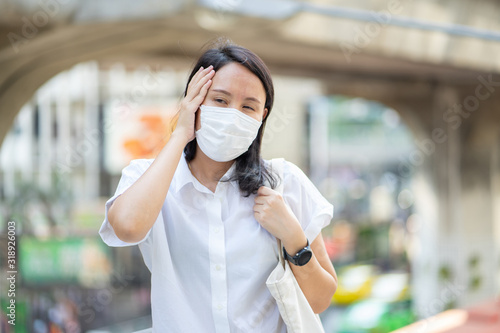 Woman wearing face mask protect filter against air pollution (PM2.5) or wear N95 mask. protect pollution, anti smog and viruses, Air pollution caused health problem. environmental pollution concept.