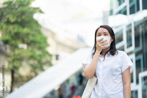 Woman wearing face mask protect filter against air pollution (PM2.5) or wear N95 mask. protect pollution, anti smog and viruses, Air pollution caused health problem. environmental pollution concept.