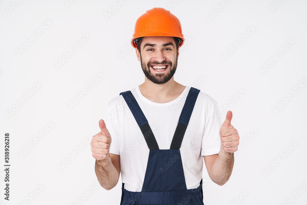 Man builder in helmet showing thumbs up gesture. Man builder in helmet showing thumbs up gesture.