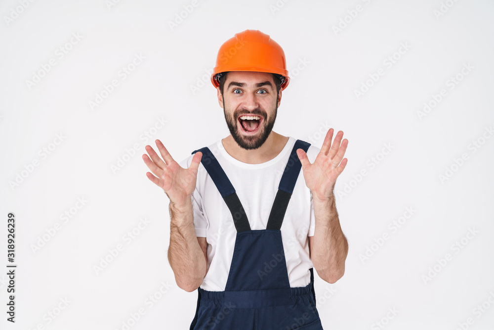 Surprised young man builder in helmet Surprised young man builder in helmet