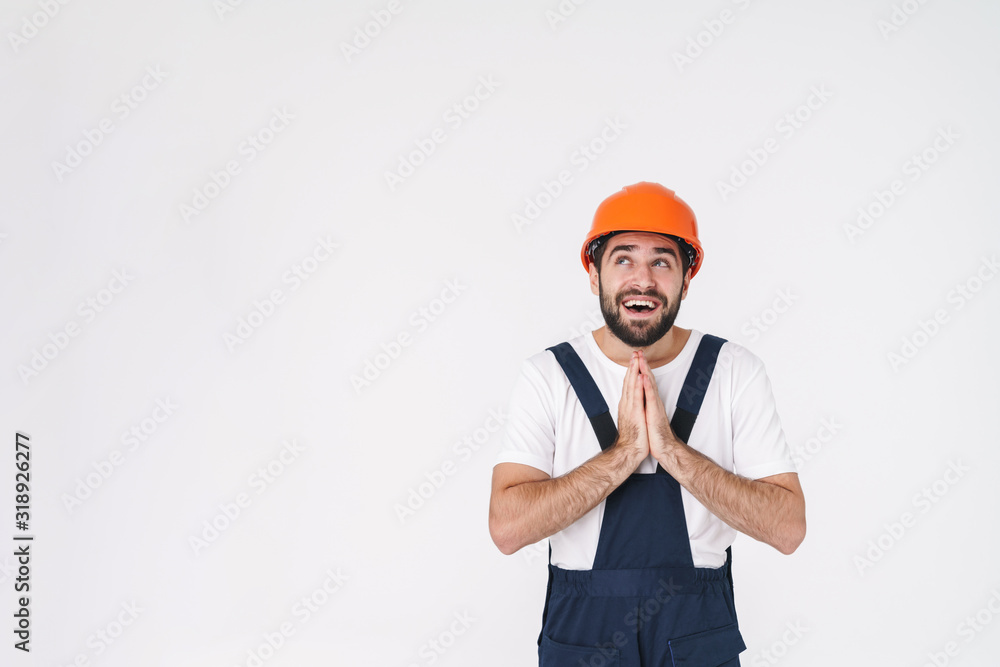 Dreaming young man builder in helmet Dreaming young man builder in helmet