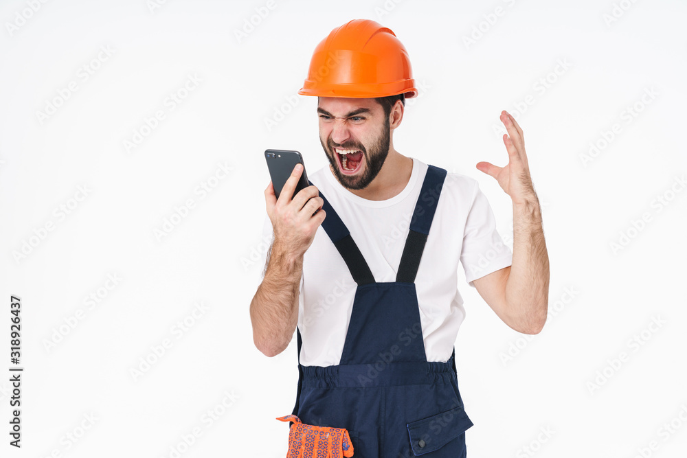 Angry screaming young man using mobile phone.